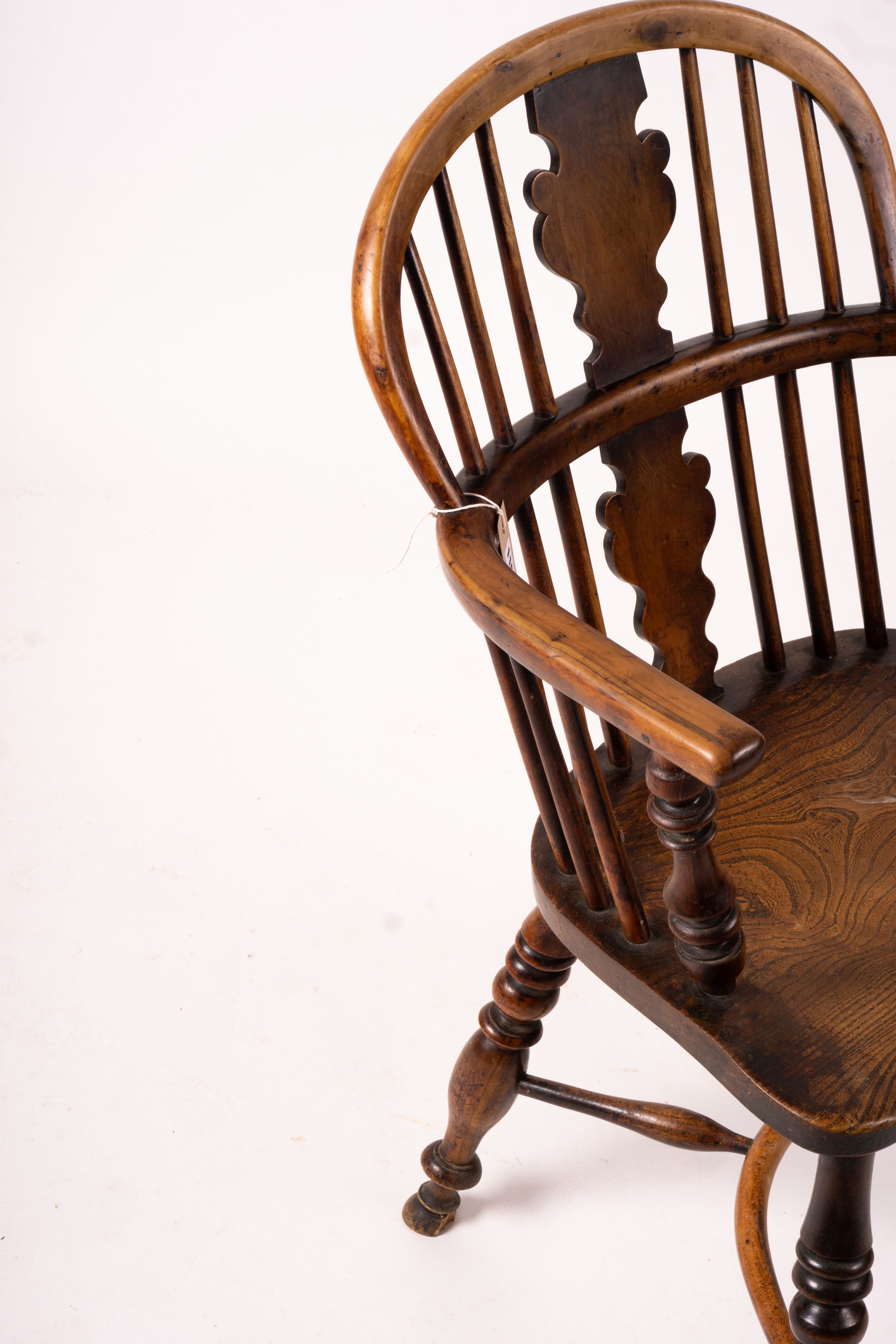 A mid 19th century yew and elm Windsor elbow chair with crinoline stretcher, width 54cm, depth 46cm, height 94cm